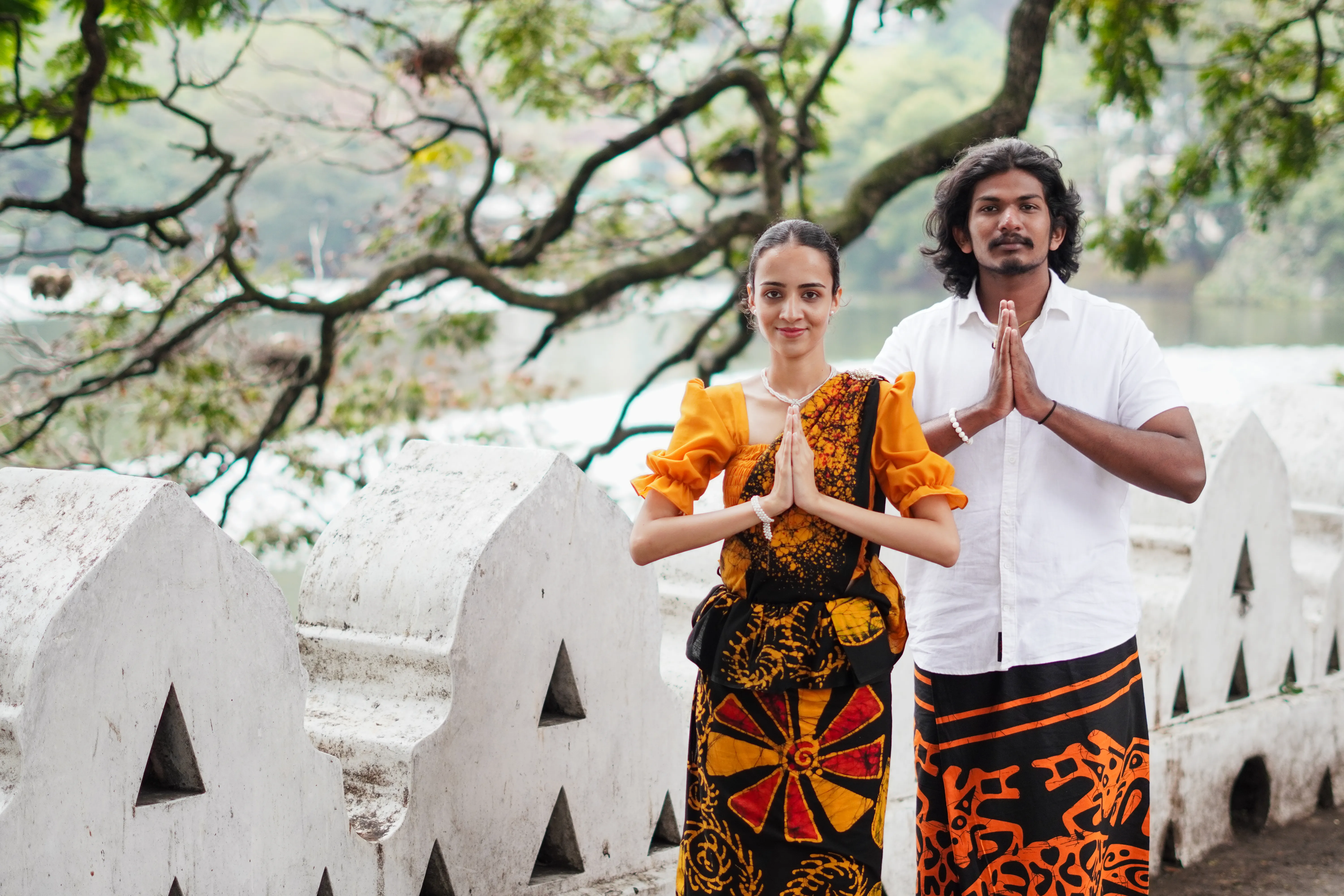 Couple in traditional Sri Lankan attire beside Kandy Lake